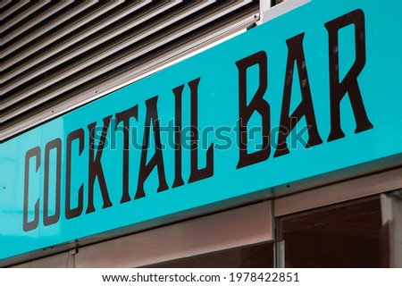 Cocktail bar sign in turquoise and black