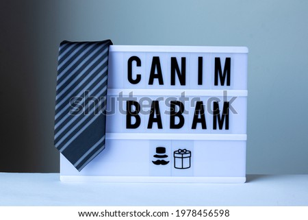 Happy Father’s Day , Happy Father’s Day concept idea, Dear Dad ( Canım Babam) sign on lightbox and with striped tie. 