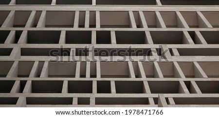 Close-up of multistory building. Windows of concrete block. Modular wall construction. Abstract modern architecture background in minimal style. Geometric background. Polygonal pattern of partitions.