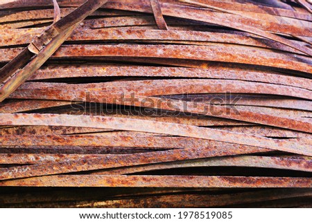 Rolled metal glass. Steel stripes of a flat section, background photo rusty texture
