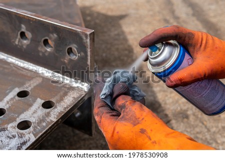 Step to use solvent remover spray into the rag to cleaning the welded surface before performing spray Liquid Penetrant for Non-Destructive Testing(NDT) with process Penetrant Testing(PT). Royalty-Free Stock Photo #1978530908