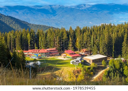 Bansko, Bulgaria Shiligarnika autumn ski resort view with hotel house, mountains and ski lift Royalty-Free Stock Photo #1978539455