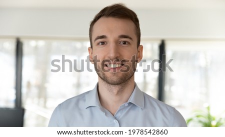 Head shot portrait of smiling confident businessman looking at camera, successful executive employee intern posing for corporate photo, profile picture, coach mentor shooting webinar, recording video