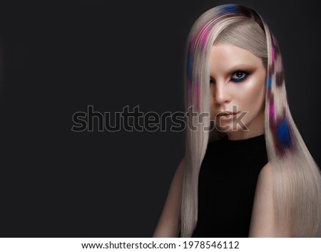 Beautiful girl with multi-colored hair and creative make up and hairstyle. Beauty face.