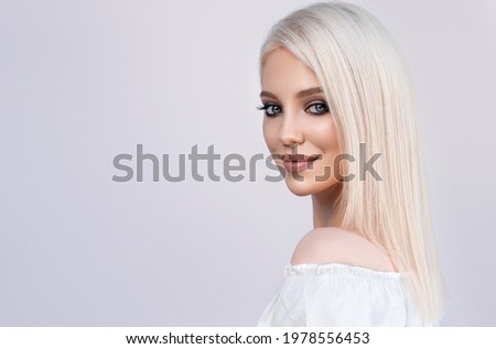 Beautiful girl with hair coloring in ultra blond. Stylish hairstyle done in a beauty salon. Fashion, cosmetics and makeup Royalty-Free Stock Photo #1978556453