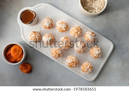 flat lay composition with raw vegan energy balls on ceramic board. healthy vegan food concept. Gray background Royalty-Free Stock Photo #1978583651