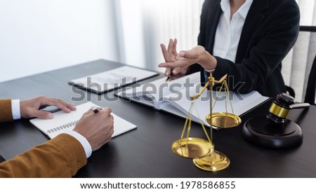 law,libra scale and hammer on the table, 2 lawyers are discussing about legal provision, law matters determination, open hand. Royalty-Free Stock Photo #1978586855