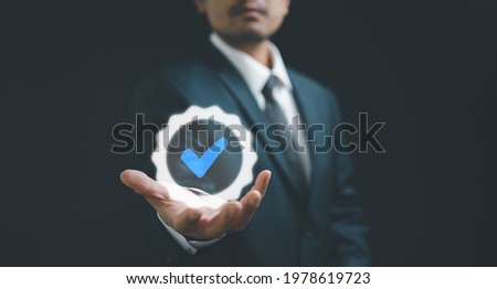 Hand shows the sign of the top service Quality assurance, Guarantee, Standards, ISO certification and standardization concept. Royalty-Free Stock Photo #1978619723