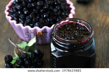 Chokeberry jam, berries in sugar syrup Aronia, Black chokeberry. canning berries for the winter,  Royalty-Free Stock Photo #1978619885