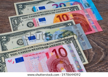 european euro and american dollars banknotes on wooden table