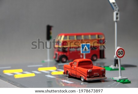 Road safety concept - toy crossroad with traffic signs, pickup and a bus