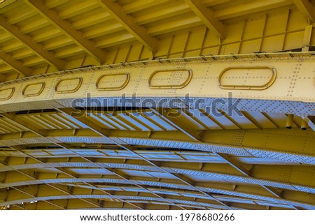 Detail of a yellow old metal bridge frame closeup. Horizontal image
