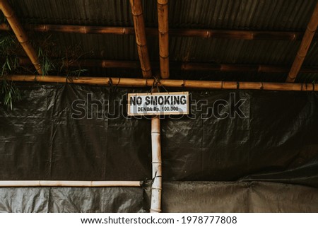 a sign prohibiting smoking or being fined