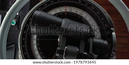 Compass aboard large ship on a blue summer sea ocean day