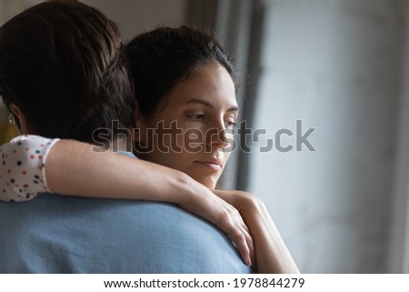 Head shot unhappy thoughtful young woman cuddling husband, feeling stressed after conflict, thinking of psychological problems in family relations, upset wife suspecting betrayal or cheating. Royalty-Free Stock Photo #1978844279