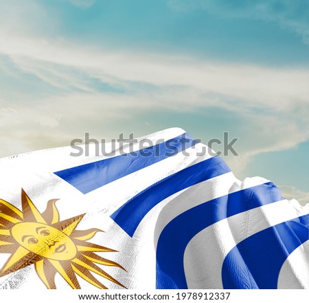 Uruguay waving flag in the sky.
