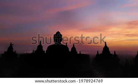 A picture of Budha statue on top of Borobudur temple, Indonesia just before the sun appear