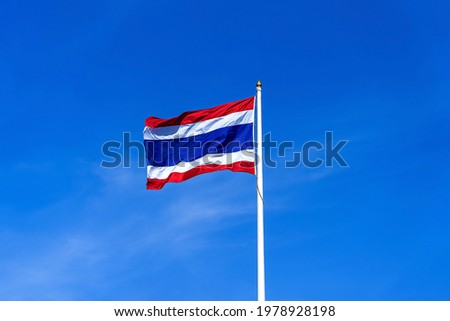 Flag of Thailand waving in the wind. Image of waving Thai flag of Kingdom of Thailand with blue sky background and copy space. Thailand international flag on top of the pole against clear blue sky.