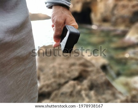 Hand holding action camera isolated. Monopod hold in arm. Active cam.