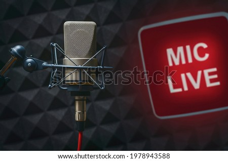 Professional microphone in radio station studio and on air sign