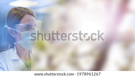 Composition of smiling female scientist wearing face mask in laboratory with copy space. science and research concept digitally generated image.