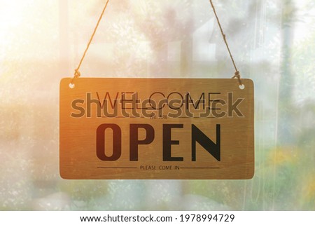 Welcome we are Open sign hanging outside a restaurant, store, office or other,business open back to new normal after coronavirus.