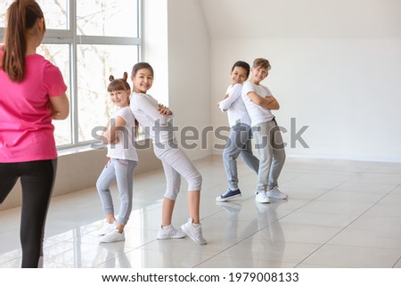 Cute little children with teacher in dance studio