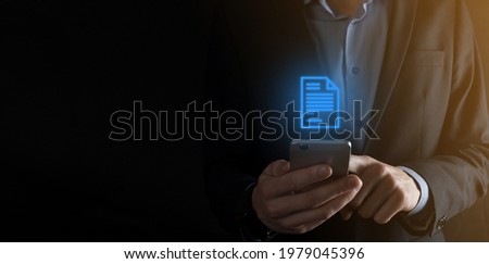 Businessman man holding a document icon in his hand Document Management Data System Business Internet Technology Concept. Corporate data management system DMS .