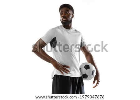 Close-up young African soccer football player posing with ball isolated on white background. Concept of sport, power, team sport, movement, energy and dynamic, health. Copy space for ad.