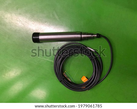 Turbidity sensor for measurement and monitoring quality water in clarifier tank, industrial waste water treatment system, out of focus, noise and grain effects, selective focus.