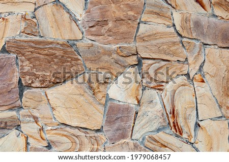 Rainbow Sandstone. Clastic sedimentary rock composed mainly of sand-sized silicate grains. Stone wall. Background. Close up. sandstone is composed of quartz or feldspar.