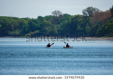 two canoeists paddle in beautiful weather on the Baltic Sea
