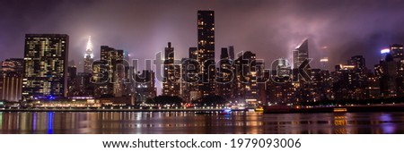 Manhattan skyline at night with reflections. view of New York City, USA. Panoramic view
