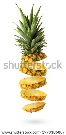Flying fresh pineapple slices isolated on white background. Creative food concept.