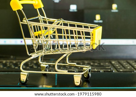 the concept of business and trade on the Internet shopping cart lies on the keyboard of the laptop. High quality photo