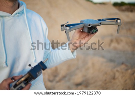 Man Operating A Drone In Nature