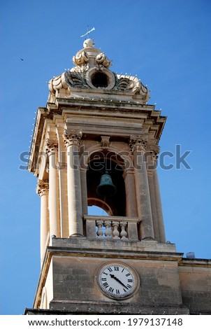 
Malta, a tower of a historic building with a clock