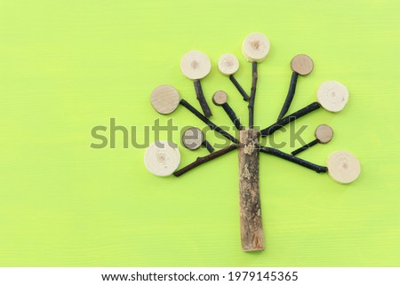 Image of wooden growing family tree on green background