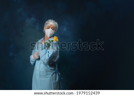 Nurse with a yellow rose in the studio