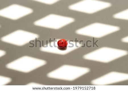 Shadows with realistic geometric shapes with cubes or diamonds and a red seed in the center.