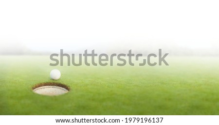 Composition of golf ball on golf course over white blur. sport, fitness and active lifestyle concept digitally generated image.