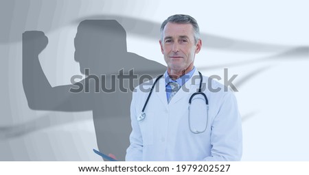 Composition of smiling male doctor and male athlete shadow with copy space on white. medicine and healthcare services concept digitally generated image.