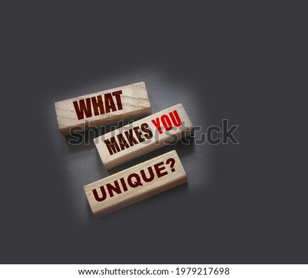 What makes you unique - phrase on Wooden blocks. Business or career success concept.