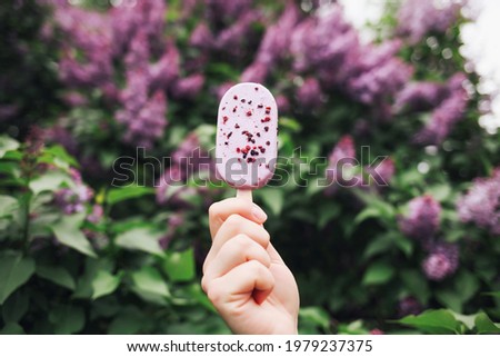 Outdoor closeup portrait of young hipster crazy girl eating ice cream in summer hot weather in glasses have fun and good mood. Toned style instagram filters