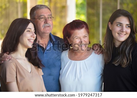 happy family looking out the window at home. parents and their daughter.