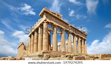 Acropolis, ancient Greek fortress in Athens, Greece. Panoramic image of Parthenon temple on a bright day with blue sky and feather clouds. Classical Greek heritage, famous place.