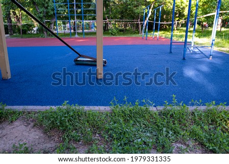 Laying the floor covering on the sports field. Modern flooring for the playground. Royalty-Free Stock Photo #1979331335