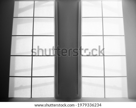 Glass wall with frames and panels. Abstract modern business architecture. Interior of commerical real estate. Office building. Regular geometrical background with checkered structure of square tiles.