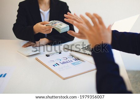 Businessperson refusing bribe given money  by Colleague with anti bribery corruption concept.