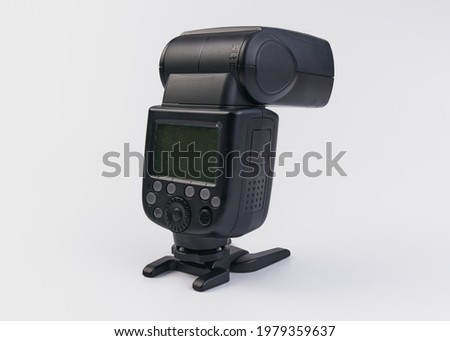 Handheld flash for photographic camera on a white background